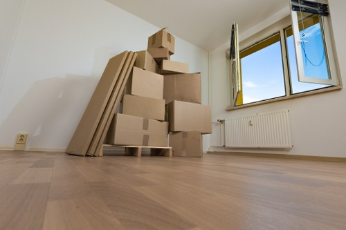 Packed boxes and furniture ready for a local house removal service